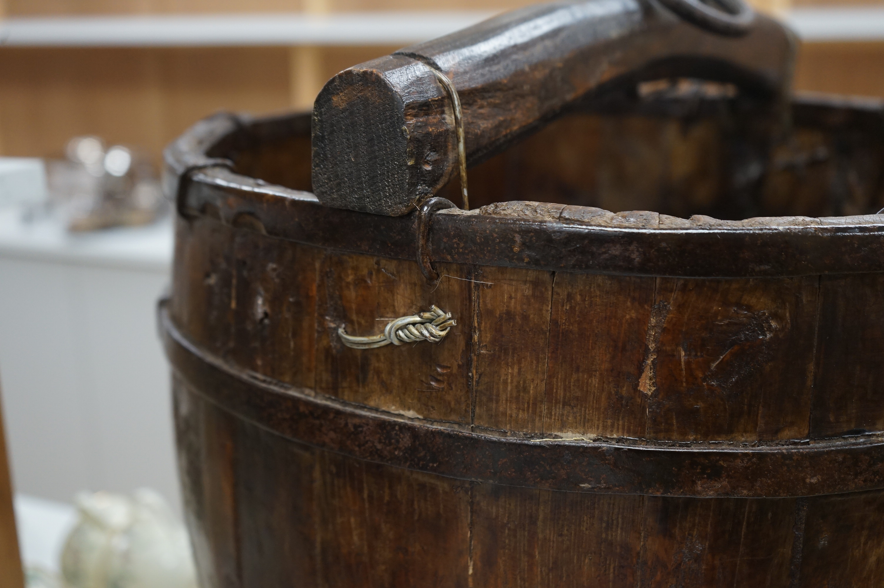 A Chinese wooden and metal bound pail on stand, approximately 55 cm high. Condition - good